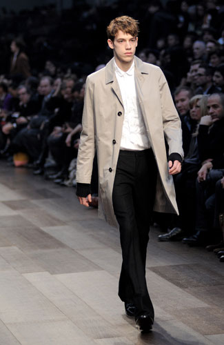 Look The Business: A male model wears a Burberry mac on the catwalk
