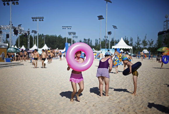 24 hours: Beijing, China: People head for the pool at a water park 