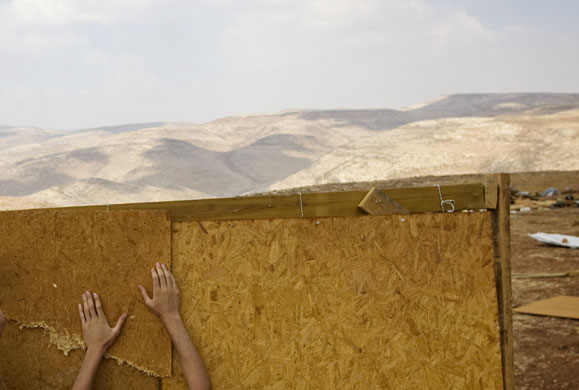 24 hours: A Jewish settler rebuilds a structure earlier demolished by Israeli police