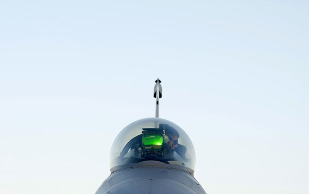 24 hours: Ground crew works in the cockpit of a fighter jet at Bagram air base