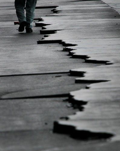 24 hours: A man walk by cracks following a 6.5-magnitude earthquake in Japan 