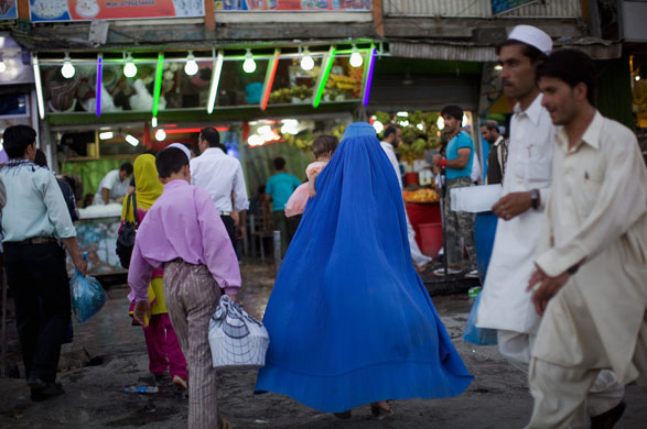 12 August 2009: Kabul, Afghanistan: Men and women walk through a market
