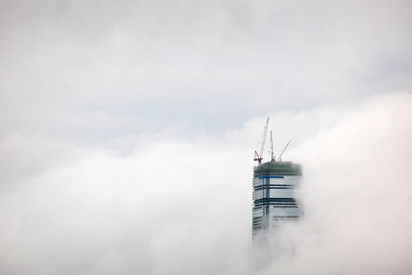 12 August 2009: Hong Kong, China: Cranes stand atop the partially-completed ICC