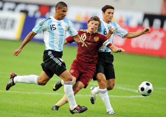 Football round the globe: Andrey Arshavin challenges for the ball