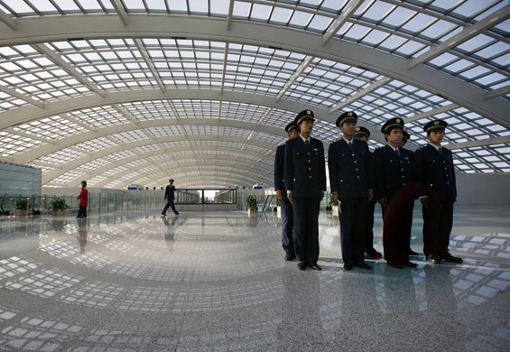 Airport design: Guards at the $3.6bn new terminal at Beijing airport