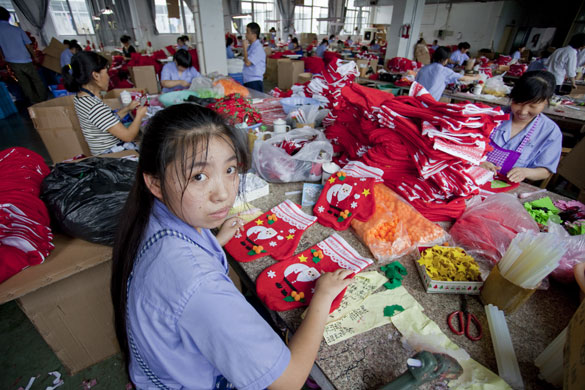 Christmas production line: Workers assemble Christmas stockings on the production line in Yiwa China