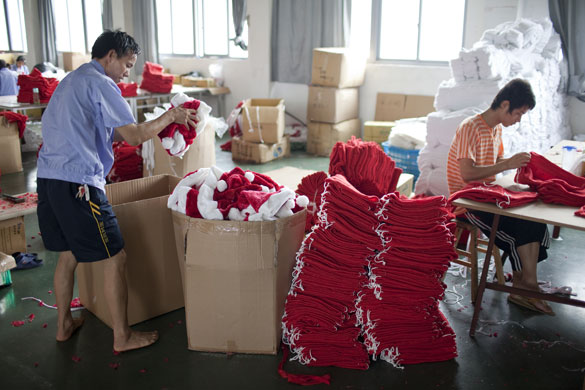 Christmas production line: Santa hats are packed into boxes from the  production line in Yiwa