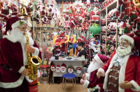 Christmas production line: A worker surrounded by Christmas products in a wholesale store in Yiwu