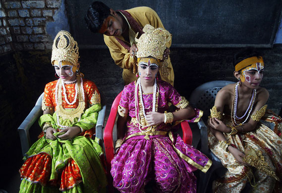 14 August 2009: Amritsar, India: An artist puts make-up on children's faces