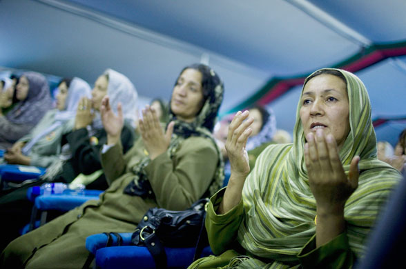 14 August 2009: Kabul, Afghanistan: Teachers pray during a campaign rally