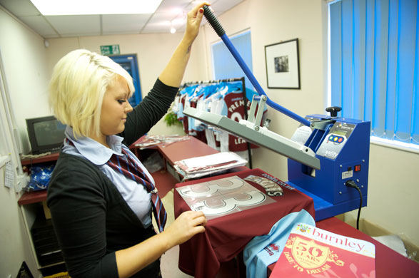 Burnley Premier League: Staff in the supporters shop are busy printing team shirts.