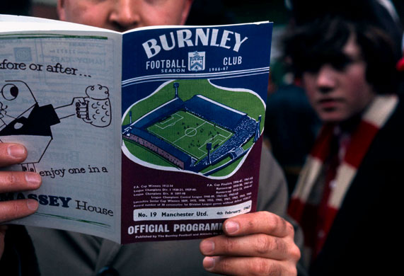 Burnley Premier League: A United fan reads his matchday programme.