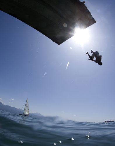 24 hours in pictures: Lutry, Switzerland: A swimmer dives into lake Leman on a hot summer's day 