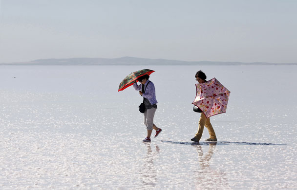 24 hours in pictures: Ankara, Turkey: Tourists walk on Tuz Golu which means Salt Lake