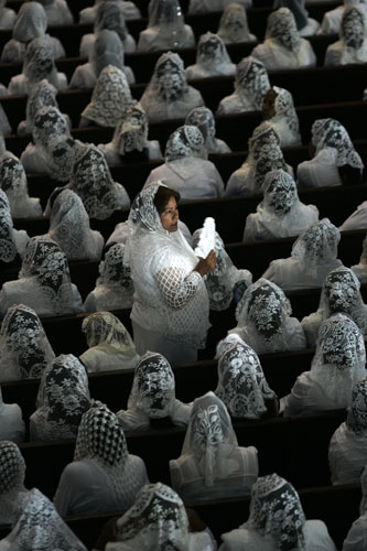 24 hours in pictures: Guadalajara, Mexico: A worshipper stands amongst the congregation