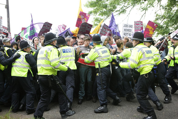 Anti-fascism rally: anti-fascism protesters are held back by a police line