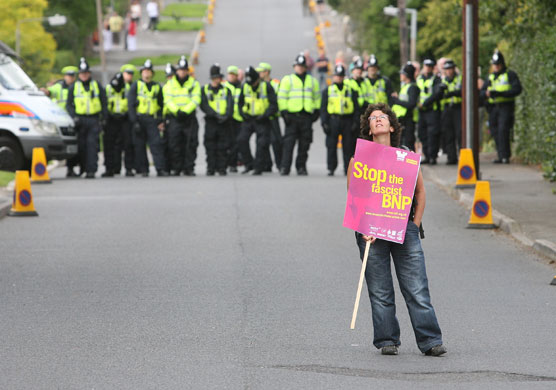 Anti-fascism rally: A lone protester with the police line behind her