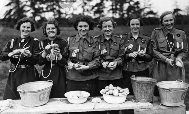 Girl guides 100th: Girl Guides in their camp, peeling potatoes 1938