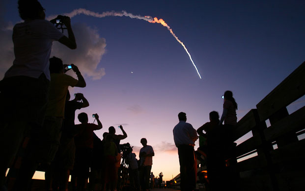 18 August 2009: Florida, US: People at Jetty Park take pictures of a  Delta 2 rocket