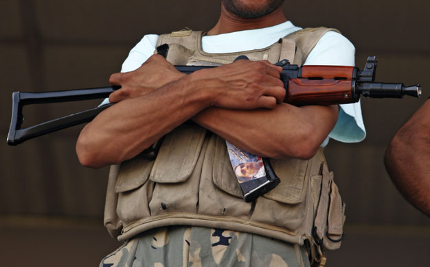 Afghanistan elections : Kabul: A security officer stands guard at a campaign rally for Dr Abdullah 