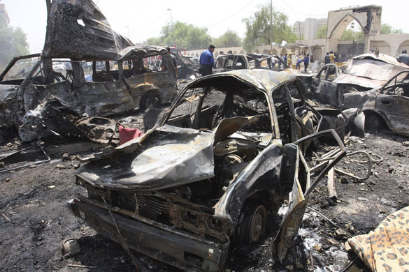 Bombings in Baghdad: Burned vehicles lie damaged outside the Foreign Ministry building