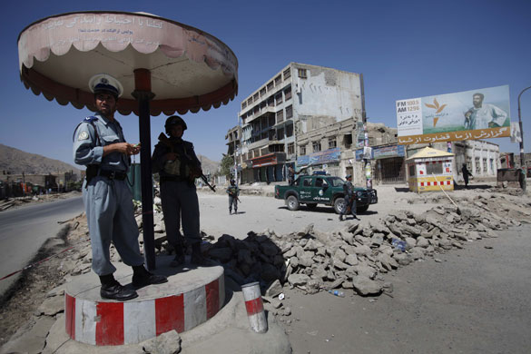 Afghanistan election: Kabul: Police guard a security checkpoint made from a pile of rocks 