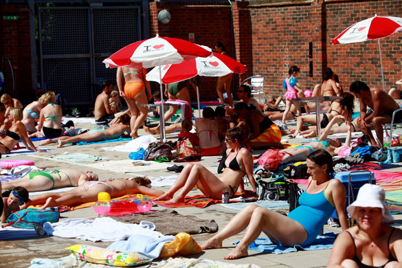 UK weather: Sunbathers enjoy the hottest day of the summer at London Fields