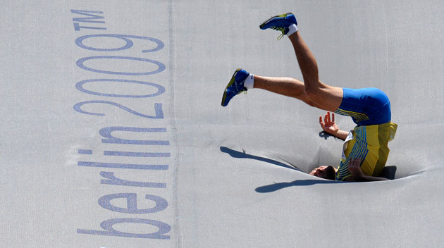 19th Athletics: Linus Thornblad lands awkwardly in the men's high jump.