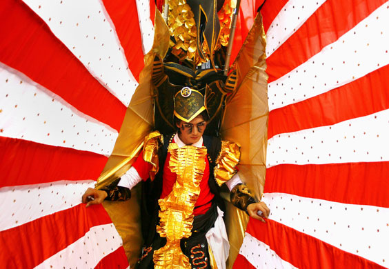 24 hours in pictures: Jember, Indonesia: A model takes part in a fashion carnival 