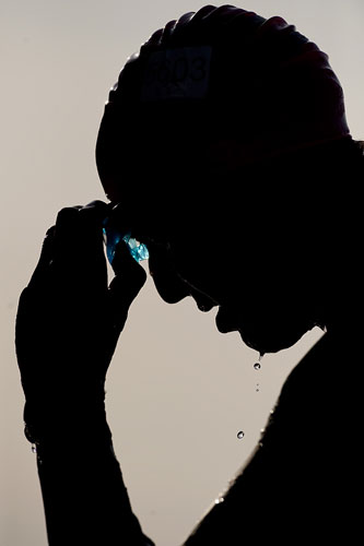 24 hours in pictures: London, UK: A competitor removes his goggles during the London Triathlon