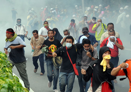24 hours in pictures: Kuala Lumpur, Malaysia: Demonstrators flee as police fire tear gas shells