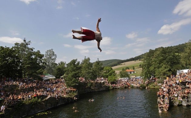 24 hours in pictures: Czech Republic: A competitor jumps during a cliffdiving competition