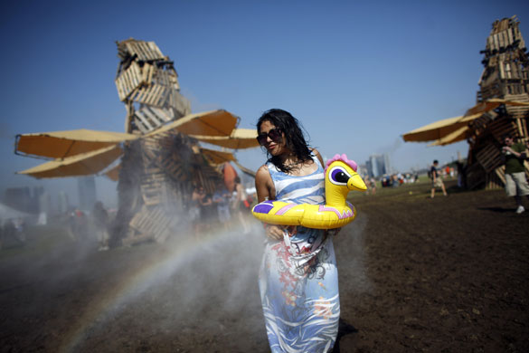 24 hours in pictures: Jersey City, New Jersey, USA: A woman is sprayed at a misting station 