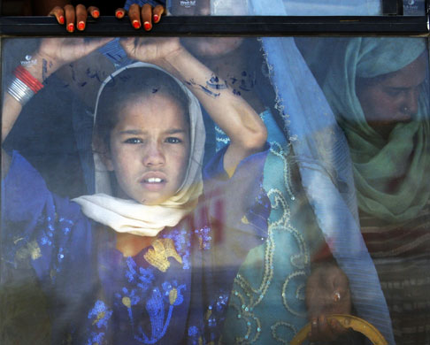 24 hours in pictures: Kabul, Afghanistan: A girl looks out of a bus window 