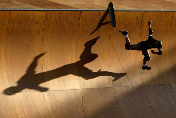 24 hours in pictures: Carson, California, USA:  Rune Glifberg falls off of his skateboard 