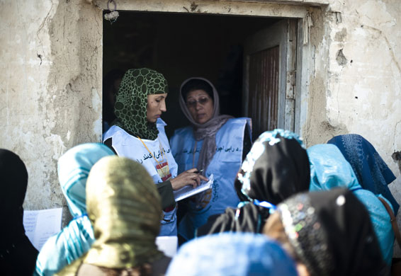 Elections in Afghanistan: Election workers check identification cards