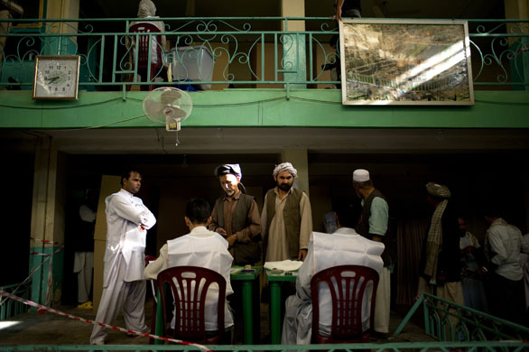 Elections in Afghanistan: Electoral workers check the identification of voters at a centre in Kabul