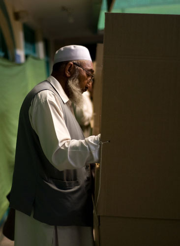 Elections in Afghanistan: A man votes inside a polling centre in Kabul
