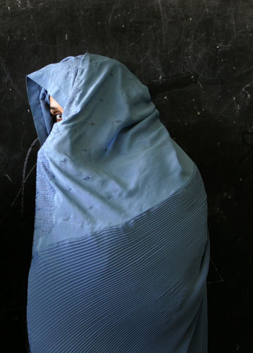 Elections in Afghanistan: A woman waits to vote in a school used a polling centre in Herat