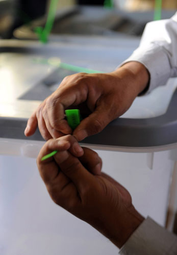 Elections in Afghanistan: An electoral worker seals ballot boxes