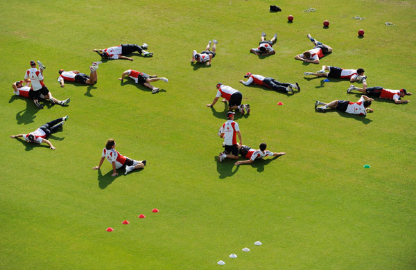 24sport: England players stretch during a warm up in a training session 