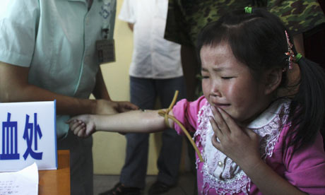 Child has blood sample taken for examination of lead levels in blood at hospital in Wugang