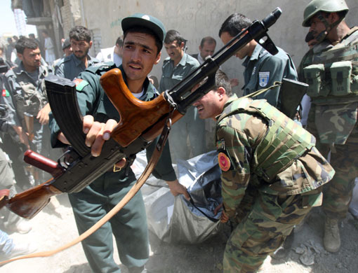 Afghanistan elections: Policemen carry the bodies of two gunmen killed after a shootout in Kabul