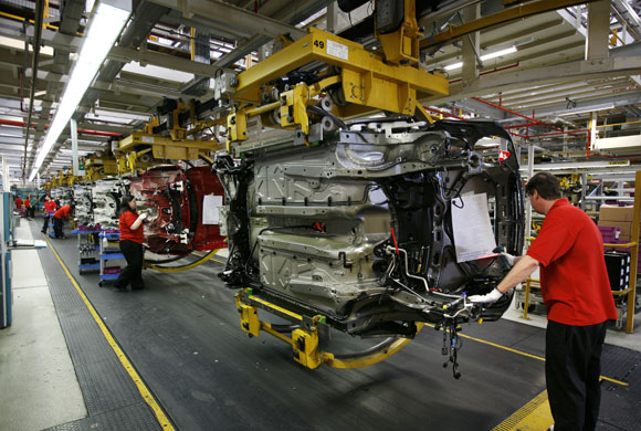 Week in business: Workers on BMW's Mini production line at their factory in Cowley, Oxford