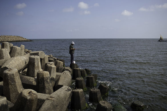 Nile Delta:  Said Mohamed Shairwi fishes from the wall built to prevent coastal erosion