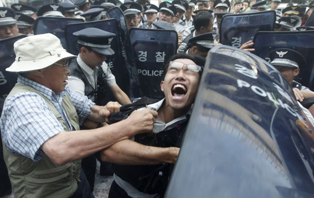 24 hours in pictures: An anti-North Korea protester scuffles with policemen in Seoul