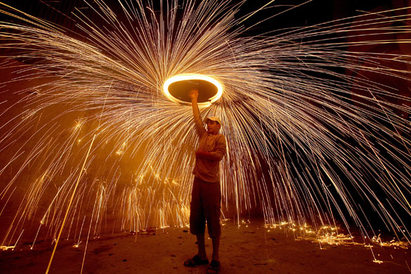 23 August 2009: Gaza City, Gaza Strip: A Palestinian youth plays with fireworks