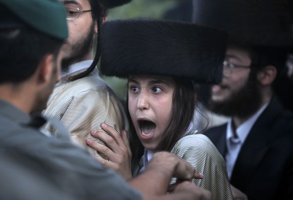 23 August 2009: Jerusalem, Israel: An Ultra-Orthodox boy shouts at police