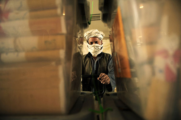 23 August 2009: Kabul, Afghanistan: An election worker unloads ballot boxes from a truck