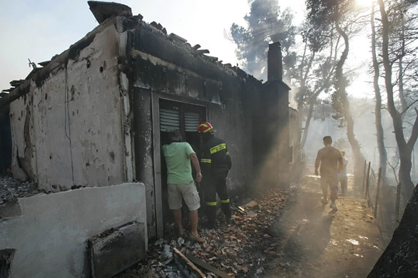 athens update:  Firemen inspect damage in the northen Athens suburb of Dionissii